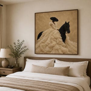 May include: A square framed wall art print featuring a figure wearing a wide-brimmed black hat and a voluminous, layered cream-colored ruffled gown, mounted on a black horse against a textured, neutral-toned background.