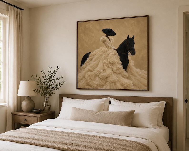 May include: A square framed wall art print featuring a figure wearing a wide-brimmed black hat and a voluminous, layered cream-colored ruffled gown, mounted on a black horse against a textured, neutral-toned background.