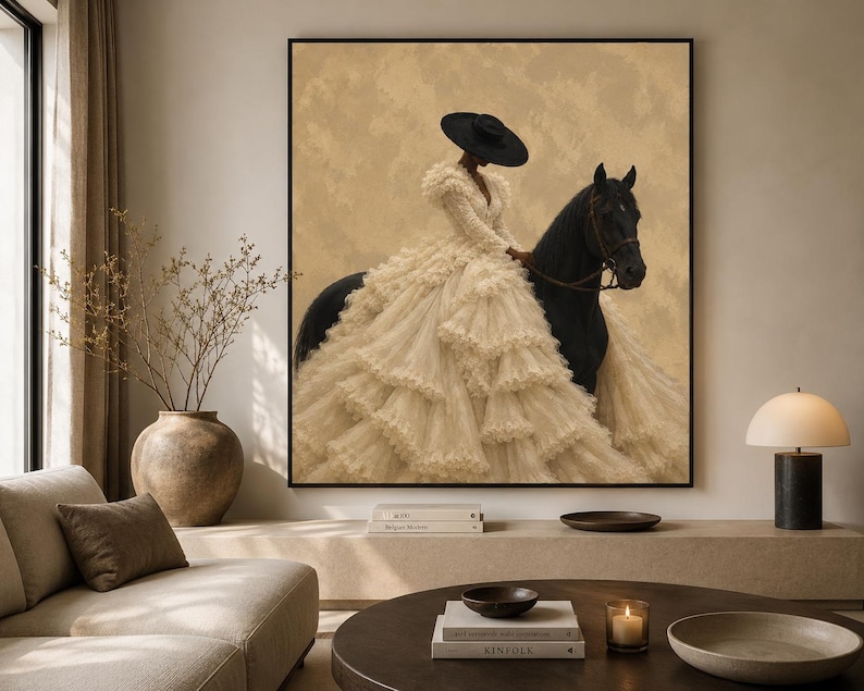 May include: A square wall art print featuring a person wearing a wide-brimmed black hat and a voluminous, tiered cream-colored ruffled gown, mounted on a black horse. The background is a textured, muted beige color with a soft, painterly finish.