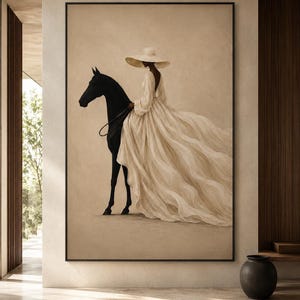 May include: A framed wall art print featuring a side profile of a black horse and a figure wearing a wide-brimmed hat and a long, flowing cream-colored dress with a deep back neckline. The artwork is displayed on a neutral-toned wall.