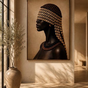 May include: A framed wall art print depicting a profile portrait of a person with dark skin, wearing a headpiece adorned with numerous light-colored cowrie shells and a layered necklace featuring dark beads and metallic accents against a tan background.
