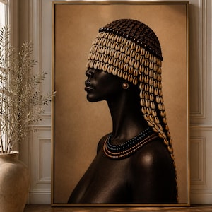 May include: A framed wall art print depicting a profile portrait of a person with dark skin wearing a headpiece covered in rows of cream-colored cowrie shells and a multi-layered beaded necklace in black and copper tones against a tan background.