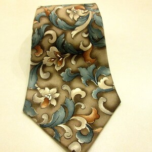 May include: A brown silk tie with a blue and orange floral pattern.