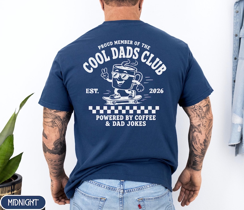 Comfort Colors 1717 Midnight t-shirt on male model featuring a white Cool Dads Club coffee mug Powered by Coffee graphic, soft unisex fit, garment dyed cotton texture, vintage washed tee for personalized dad gifts, Father's Day shirts, family style.