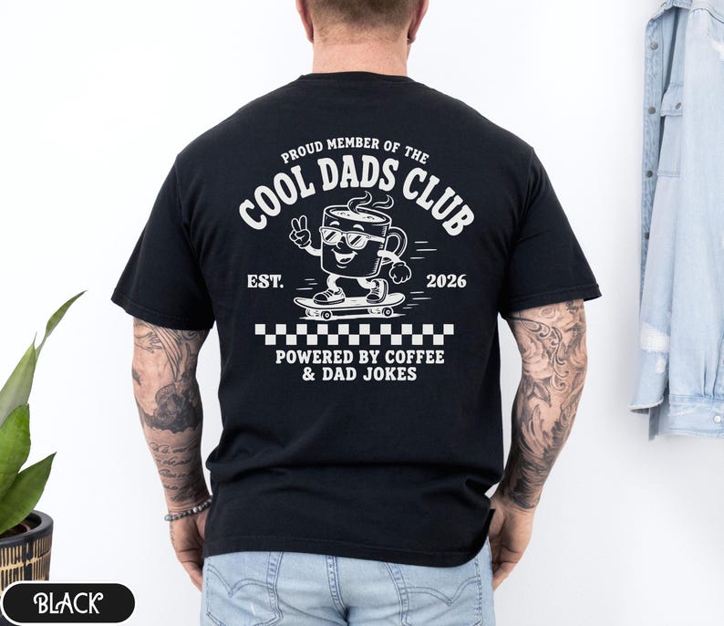 Comfort Colors 1717 Black t-shirt on male model featuring a white Cool Dads Club coffee mug Powered by Coffee graphic, soft unisex fit, garment dyed cotton texture, vintage washed tee for personalized dad gifts, Father's Day shirts, family style.