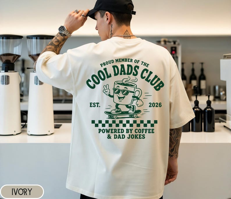Comfort Colors 1717 Ivory t-shirt on male model featuring a colored Cool Dads Club coffee mug Powered by Coffee graphic, soft unisex fit, garment dyed cotton texture, vintage washed tee for personalized dad gifts, Father's Day shirts, family style.
