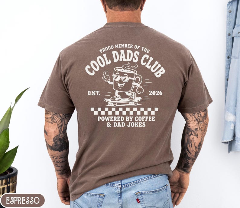 Comfort Colors 1717 Espresso t-shirt on male model featuring a white Cool Dads Club coffee mug Powered by Coffee graphic, soft unisex fit, garment dyed cotton texture, vintage washed tee for personalized dad gifts, Father's Day shirts, family style.