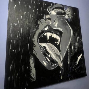 May include: A square canvas painting in black, white, and gray tones depicting a close-up of a face with an open mouth, sharp fangs, and a long tongue. The artwork features high-contrast lighting, visible brushstrokes, and dripping paint effects.