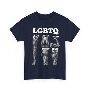 May include: A navy blue t-shirt featuring a white graphic print with the text LGBTQ at the top. Below the text are five detailed anatomical illustrations of human muscles labeled Legs, Glutes, Biceps, Triceps, and Quads in white font.