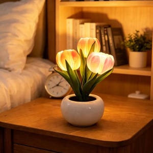 May include: A set of three ceramic mugs with a speckled, matte finish. The mugs are in shades of cream, light gray, and dark gray. Each mug has a simple, minimalist design and a rounded handle.