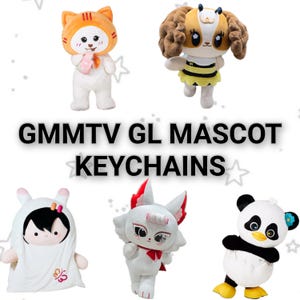 Pode incluir: Cinco chaveiros de pelúcia com o texto GMMTV GL MASCOT KEYCHAINS. Os personagens incluem uma figura com capuz de gato, uma abelha com cabelo castanho, um fantasma, uma raposa branca e um panda preto e branco.