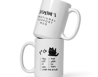 May include: Two white ceramic mugs stacked on top of each other. The top mug reads "JASMINE'S EMOTIONAL SUPPORT MUG" in black text. The bottom mug has a black cat graphic and the text "F*ck" with a list of options.