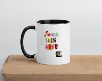 May include: White ceramic mug with a black interior and handle. The mug features the text "f*ck this shit" in colorful, cut-out style letters. A small image of a pug is below the text.