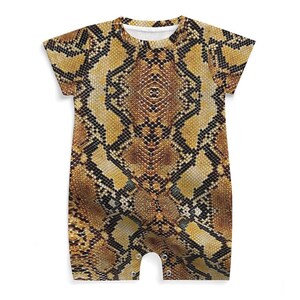 May include: A short-sleeved baby romper featuring a snakeskin pattern in shades of brown, tan, and black. The one-piece garment has a round neckline and snap closures at the bottom. The romper is designed for comfort and style.