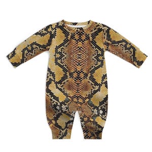 May include: A long-sleeved baby romper with a snakeskin pattern in shades of brown, tan, and black. The one-piece garment has a round neckline and snap closures at the crotch. The romper is designed for comfort and style.