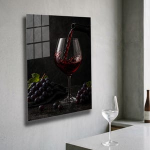 May include: A glass wall art print showing red wine being poured into a glass. Dark grapes and an empty wine glass are also visible. The image has a dark, moody aesthetic, suitable for a kitchen or dining room.