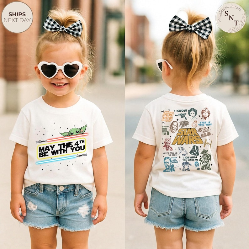 May include: A white t-shirt with the text "MAY THE 4TH BE WITH YOU" and a graphic of Baby Yoda and lightsabers. The back of the shirt features Star Wars characters and phrases. The child is wearing denim shorts and heart-shaped sunglasses.