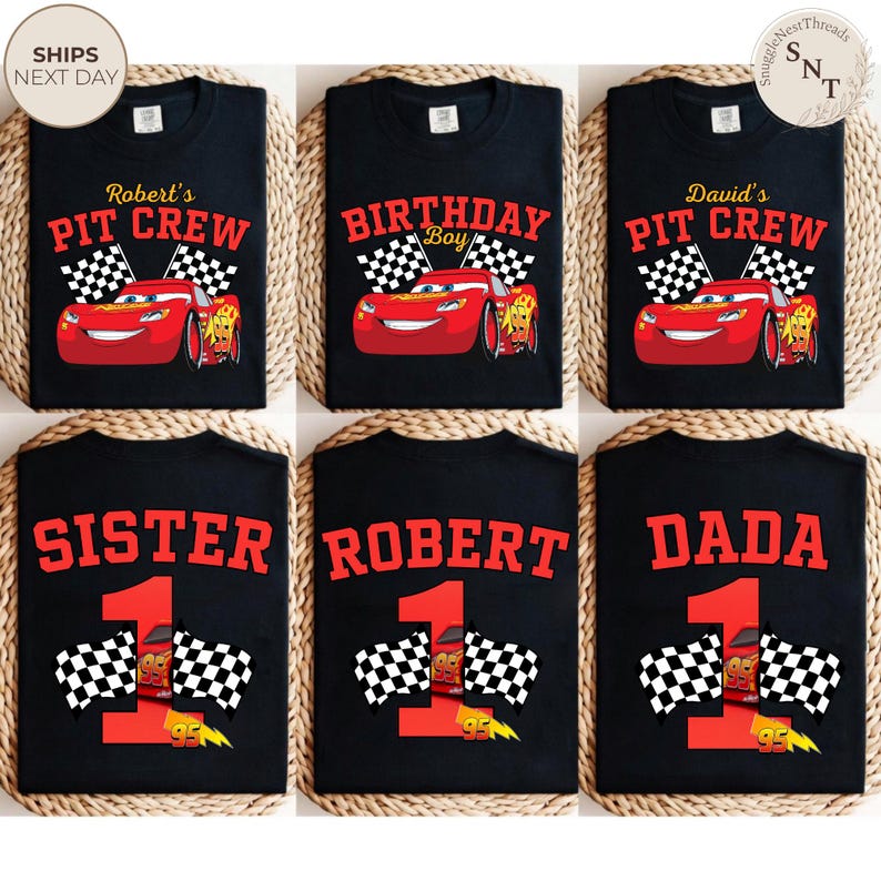 May include: Black t-shirts with various designs featuring the animated character Lightning McQueen from the movie Cars. Designs include "Robert's Pit Crew", "Birthday Boy", "David's Pit Crew", "Sister", "Robert", and "Dada". Each design includes a number 1 and checkered flags.