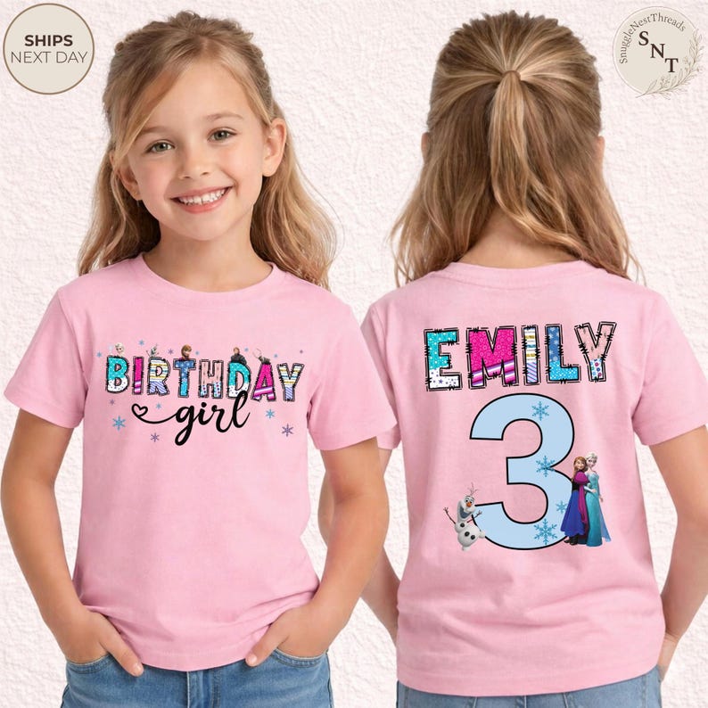 K&ouml;nnte beinhalten: Rosafarbenes T-Shirt mit kurzen &Auml;rmeln und dem Schriftzug "BIRTHDAY girl" in einem farbenfrohen Design auf der Vorderseite. Auf der R&uuml;ckseite stehen der Name "EMILY" und die Zahl "3" mit Zeichentrickfiguren.