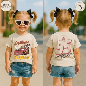 May include: A tan Lightning McQueen t-shirt with a graphic of the race car and the number 95. The front of the shirt features the text "Lightning McQueen" and "95". The back of the shirt has the number 95 and "Lightning McQueen".