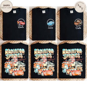 May include: Black t-shirts featuring designs from the movie Cars. Some shirts have character names like David, Laura, and Chris. Other shirts display the text "Radiator Springs" with various car characters.