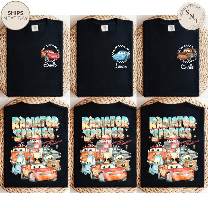 May include: Black t-shirts featuring designs from the movie Cars. Some shirts have character names like David, Laura, and Chris. Other shirts display the text "Radiator Springs" with various car characters.