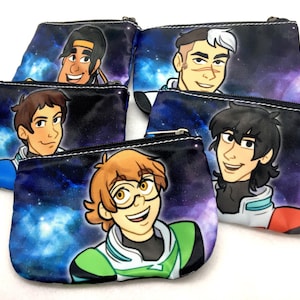 May include: Five colorful zippered pouches with a space theme. Each pouch features a different cartoon character with a galaxy background. The characters are all male and have different hairstyles and facial expressions.