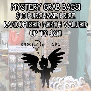 May include: A sign advertising mystery grab bags for £10. The sign reads "Mystery Grab Bagsi £10 Purchase Price Randomized Merch Valued Up To £201" and features a cartoon angel with wings. The sign is in front of a display of merchandise, including buttons, plushies, and other items.
