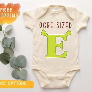 May include: A set of three ceramic mugs with a speckled, matte finish. The mugs are in shades of cream, light gray, and dark gray. Each mug has a simple, minimalist design, perfect for coffee or tea.