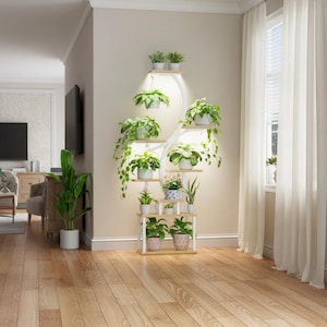 May include: A white and wood-toned plant stand with multiple shelves, displaying various potted plants. The stand has a unique, curved design with built-in lighting, creating a bright and airy display. The plants include trailing vines and flowering varieties.