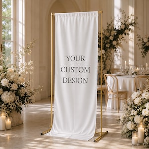 May include: A white banner with the text "YOUR CUSTOM DESIGN" displayed on a gold metal stand. The banner is in a room with floral arrangements and candles, suggesting a wedding or event setting.