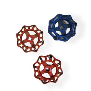 May include: Three vintage water valve handles in red and blue. The handles have a starburst design with a square center. The handles are made of metal and have a distressed finish, suggesting they are antique or reclaimed.
