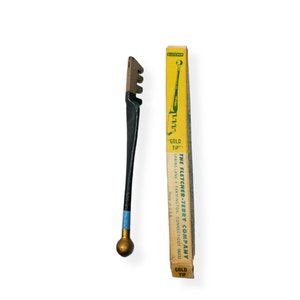 May include: A vintage glass cutter with a black handle, gold tip, and a blue accent. The cutter is next to its original yellow box, which reads "GOLD TIP" and "THE FLETCHER-TERRY COMPANY". Made in the USA.