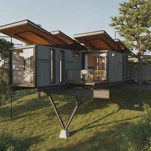 May include: Modern, elevated cabin with a dark gray exterior and a brown wooden roof. The cabin features large windows, a small balcony, and is supported by angled steel beams on a grassy hillside.
