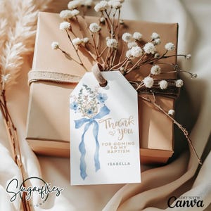 May include: White gift tag with blue watercolor flowers and a blue ribbon. The tag says "Thank you for coming to my baptism Isabella".