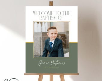 May include: A white and green welcome sign for a baptism with a photo of a young boy in a suit. The sign says "Welcome to the Baptism of Jamie Williams June 19th 2023".