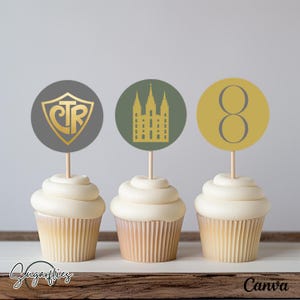 May include: Three cupcakes with gold foil cupcake toppers. The toppers feature a gold CTR logo, a gold temple silhouette, and a gold number 8. The cupcakes are on a wooden surface.