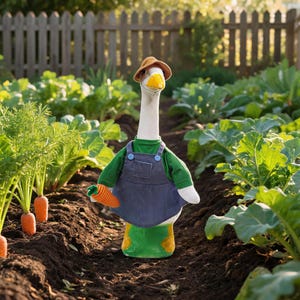 May include: A plush goose figurine wearing a brown hat, a green shirt, and blue denim overalls. The goose has a white neck, a yellow beak, and orange feet. It is holding a small orange carrot in its wing, standing upright in a garden setting.