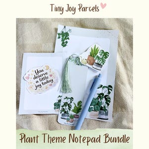 May include: A plant theme notepad bundle with stickers, a pen, and a tassel. The stickers feature potted plants and the phrase "You deserve a little joy today." The notepad bundle is on a beige surface.
