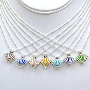 May include: Nine silver necklaces with a fan-shaped charm. The charms are in different colors, including blue, green, pink, and yellow.