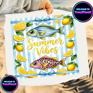 May include: White beach towel with a blue striped design, featuring illustrations of fish, lemons, and the text "Summer Vibes" in gold. The towel has blue bows and the text "WELCOME TO TrendTeesX" in a circle.
