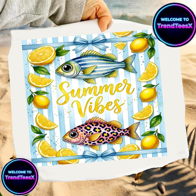 May include: White beach towel with a blue striped design, featuring illustrations of fish, lemons, and the text "Summer Vibes" in gold. The towel has blue bows and the text "WELCOME TO TrendTeesX" in a circle.