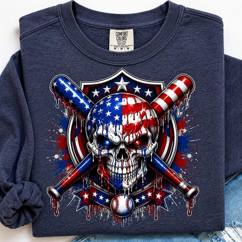 May include: A navy blue crewneck sweatshirt featuring a graphic of a skull with a melting American flag pattern, positioned in front of two crossed baseball bats. A baseball sits below the skull, all set against a shield and star background.