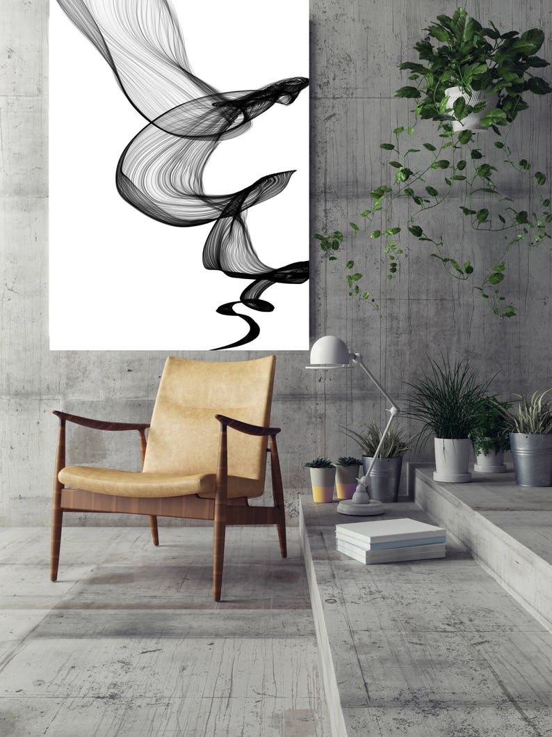 May include: A black and white abstract art print hangs on a concrete wall above a brown leather armchair. The room is decorated with potted plants and books.