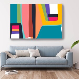 May include: Abstract art canvas print featuring a vibrant composition of geometric shapes. The artwork showcases a palette of teal, pink, orange, yellow, and purple against a white background. The canvas is displayed above a light blue sofa, creating a modern interior design.