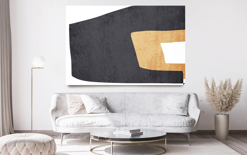 May include: Abstract art print featuring a large black shape with a smaller gold shape inside. The shapes are set against a white background.