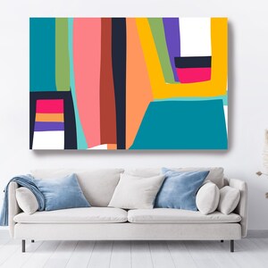 May include: Abstract art canvas print featuring a vibrant composition of geometric shapes and bold colors. The artwork showcases vertical and horizontal lines in shades of teal, pink, orange, and yellow, creating a modern and eye-catching design. The canvas is displayed above a white sofa.