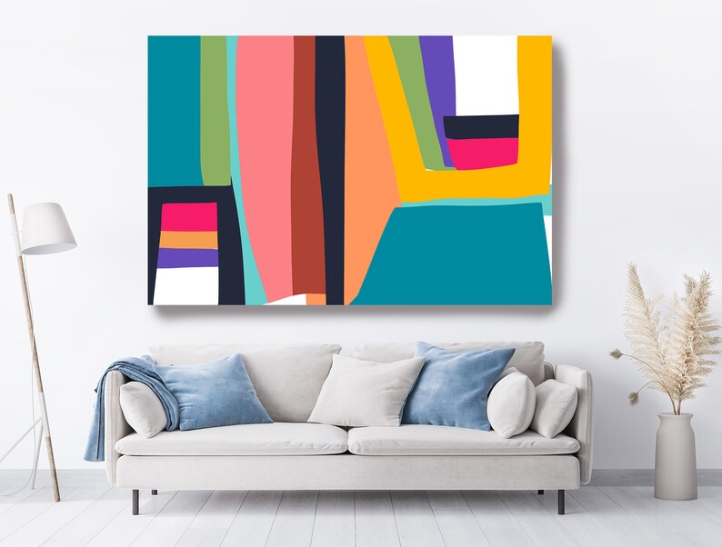 May include: Abstract art canvas print featuring a vibrant composition of geometric shapes and bold colors. The artwork showcases vertical and horizontal lines in shades of teal, pink, orange, and yellow, creating a modern and eye-catching design. The canvas is displayed above a white sofa.