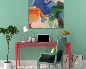May include: A red desk with a teal chair and a laptop computer. The desk has a lamp and a painting of abstract shapes in blue, green, orange, and white.