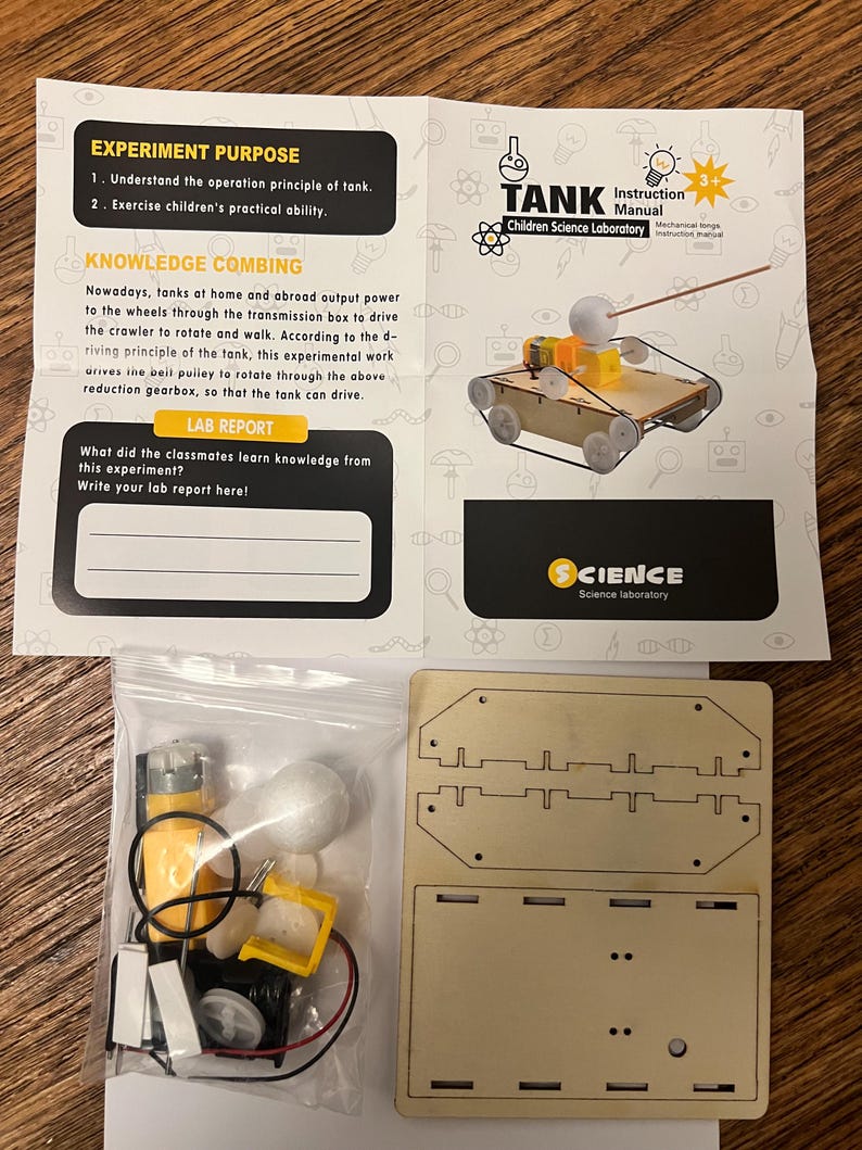 May include: A children's science laboratory kit with a tank model. The kit includes a wooden base, a bag of components, and an instruction manual. The manual explains the tank's operation principle. The kit is designed for children aged 3+.